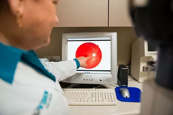 dr. tandon inspecting a patient's retina