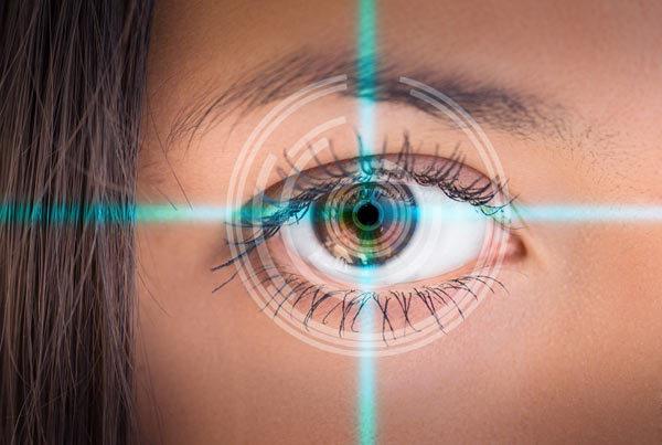 Woman's eye with laser crosshairs pinpointing center. LASIK Eye Surgery concept.