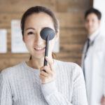 Woman covering eye during eye exam