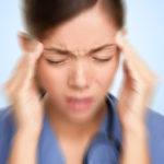 Woman suffering from migraine with aura.