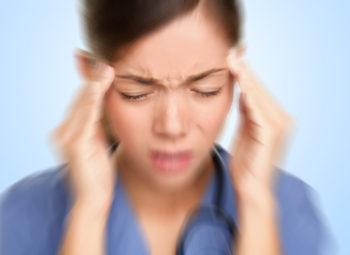 Woman suffering from migraine with aura.