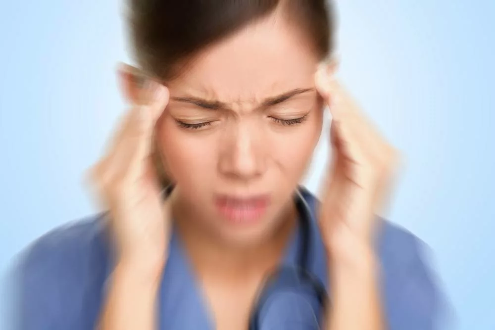 Woman suffering from migraine with aura.