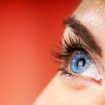 close up of woman with blue eyes suffering from eye allergies