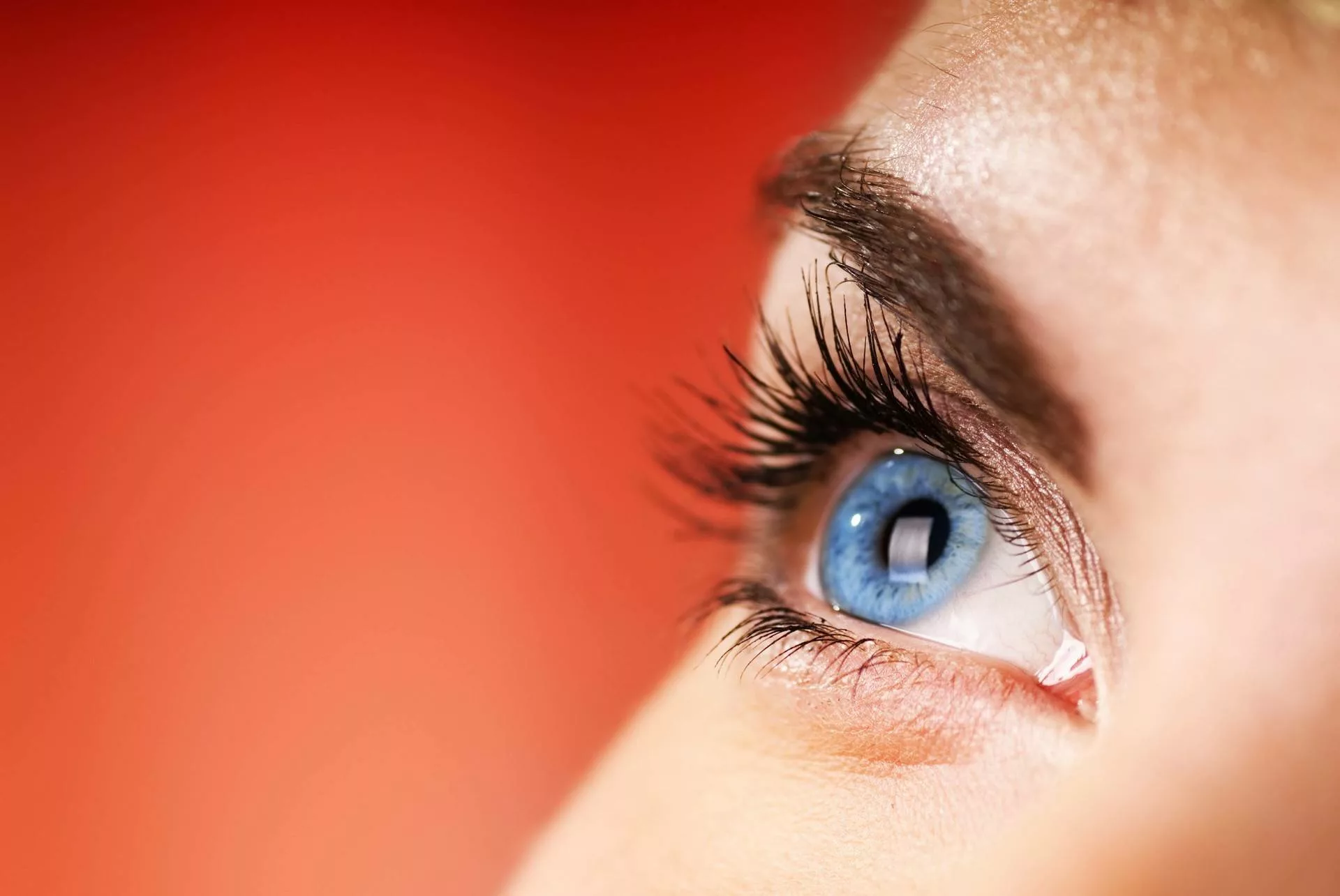 close up of woman with blue eyes suffering from eye allergies