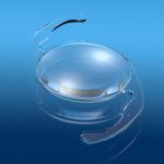 close up view of intraocular lens on blue background