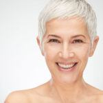 Portrait of beautiful senior woman in front of white background.