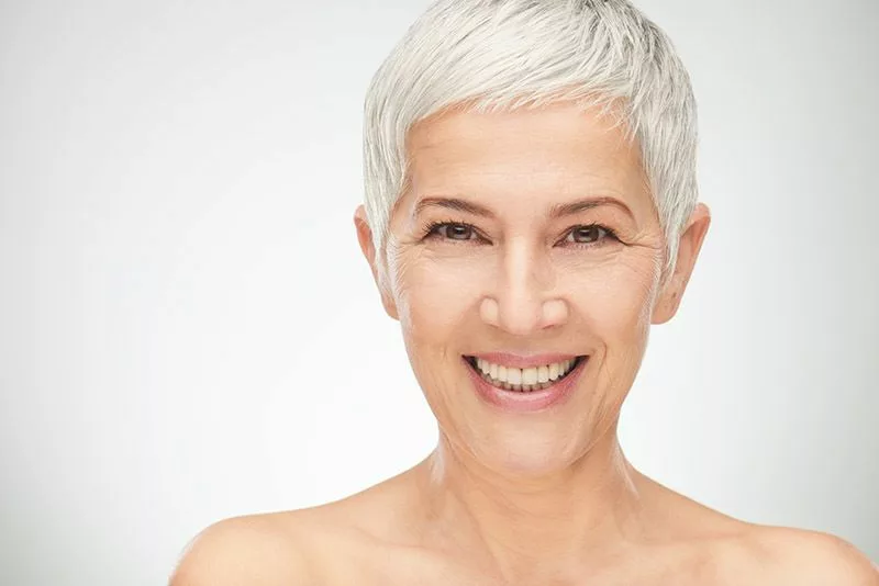 Portrait of beautiful senior woman in front of white background.