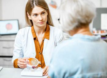 senior women speaking with eye doctor during a cataract surgery consultation