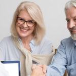 Happy senior couple meeting with doctor after cataract surgery
