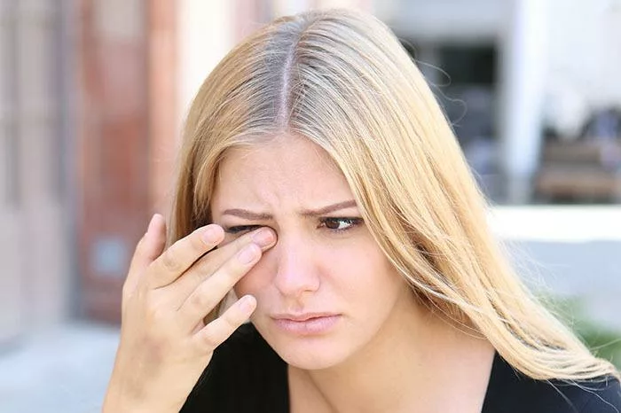 blonde women with eye pain