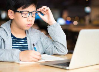 child wearing glasses to protect against digital eye strain