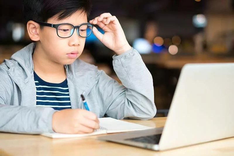 child wearing glasses to protect against digital eye strain