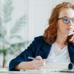 women in eyeglasses on laptop researching LASIK surgeons