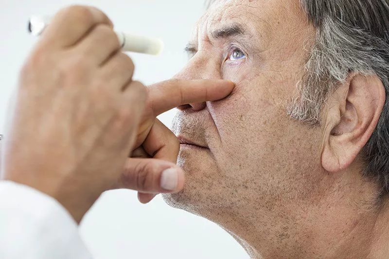 Man gets an eye exam to view the progression of cataracts