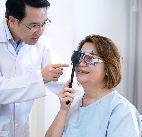 Female adult patients being at ophthalmologist appointment participating in a vision exam for lazy eye (amblyopia)