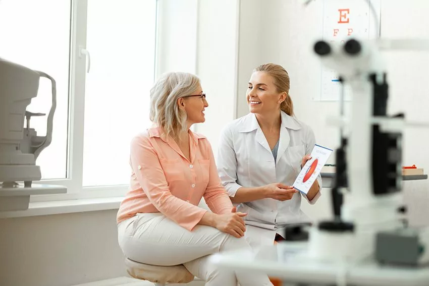 Ophthalmologist explaining something to a patients during an in office consultation