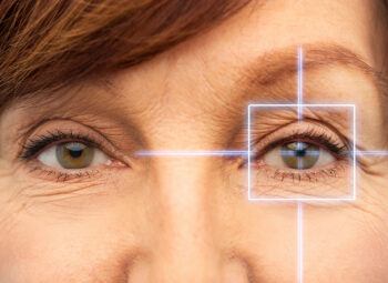 middle-aged woman's eyes with crosshairs over one