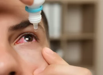 close-up of a man using eye drops