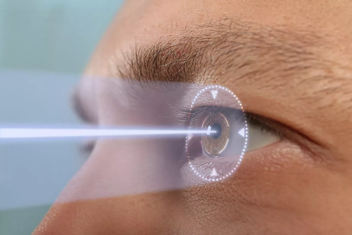 Man's upper face in profile with laser beam going to eye