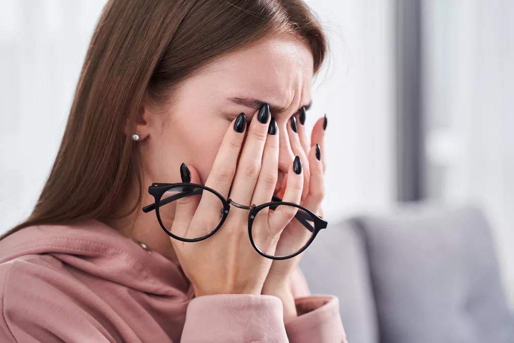 Woman with glasses has itchy eyes