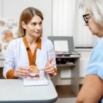 A female ophthalmologist consults with a patient about cataract surgery.