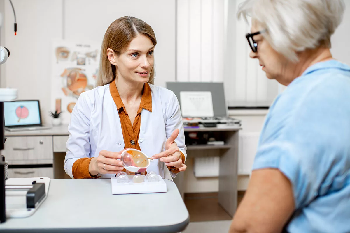 A female ophthalmologist consults with a patient about cataract surgery.