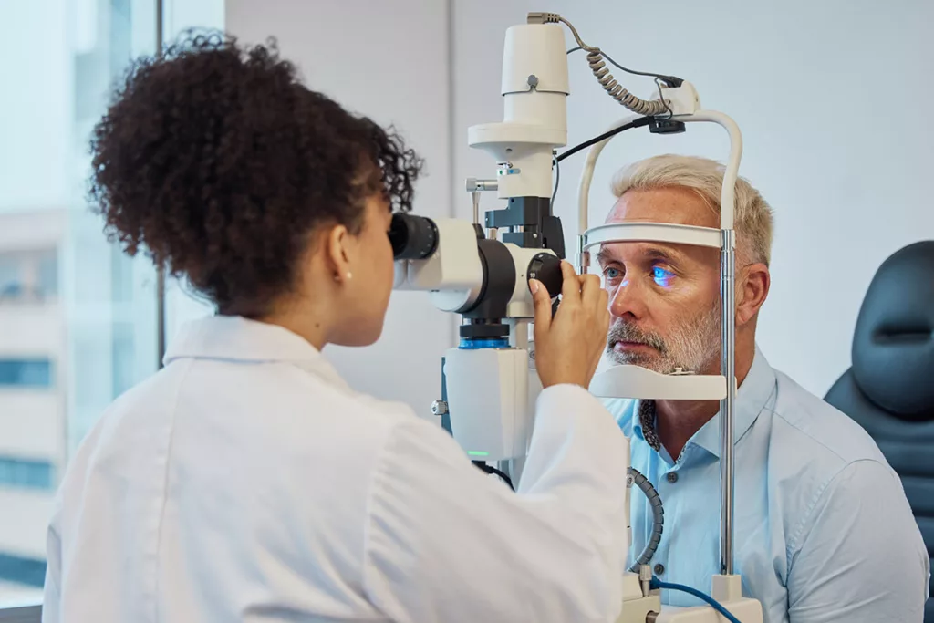 An eye doctor gives a patient a comprehensive eye exam to find the cause of his worsening night vision.