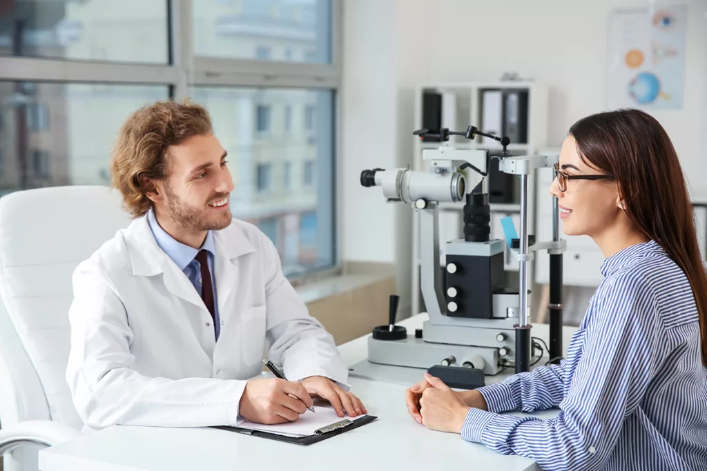 Young woman visiting ophthalmologist in clinic for an eyelid lift (blepharoplasty) consultation